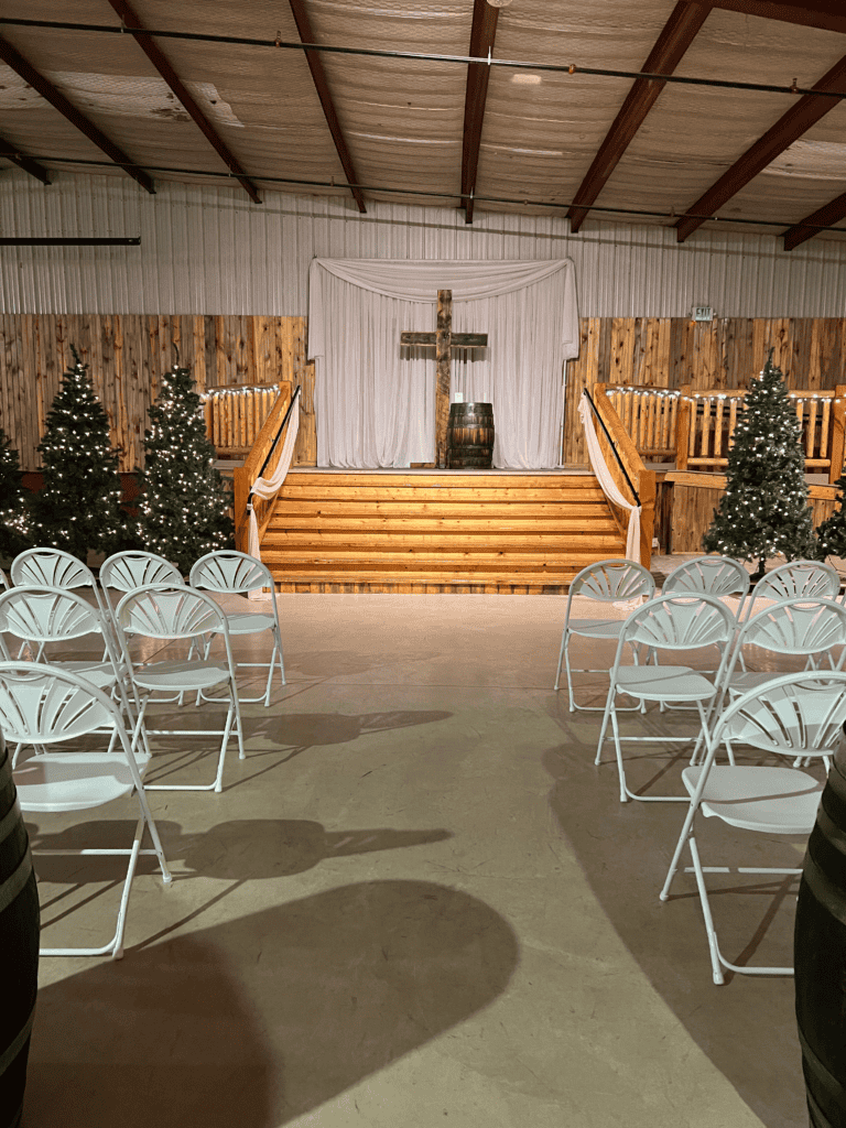 indoor winter ceremony with cross and barrel